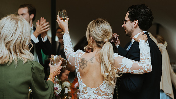 Raising a glass. A relaxed wedding reception in Burwash East Sussex