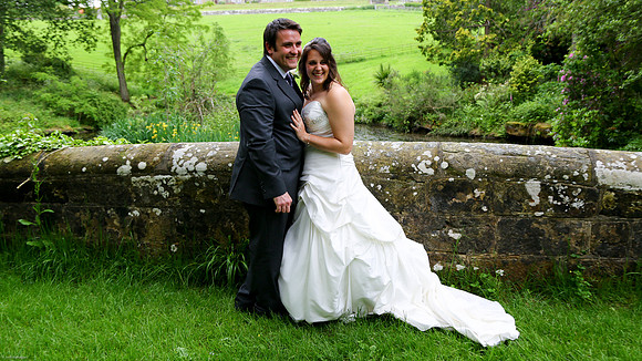 Bride and groom on the Bridge in the grounds of Worth School, Sussex